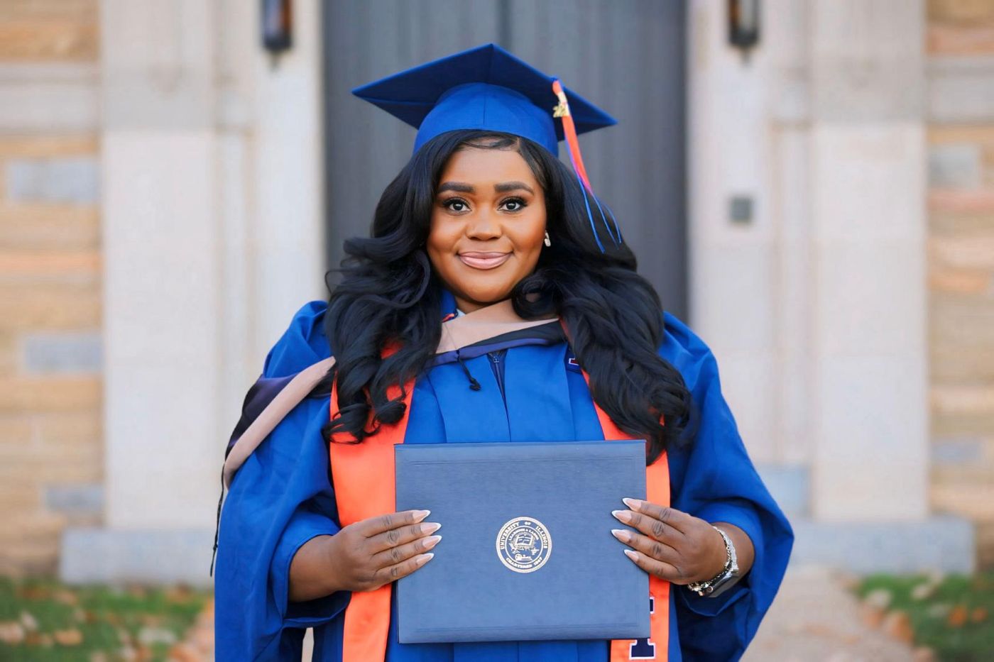 Maryann at her University of Illinois MBA graduation, holding her diploma